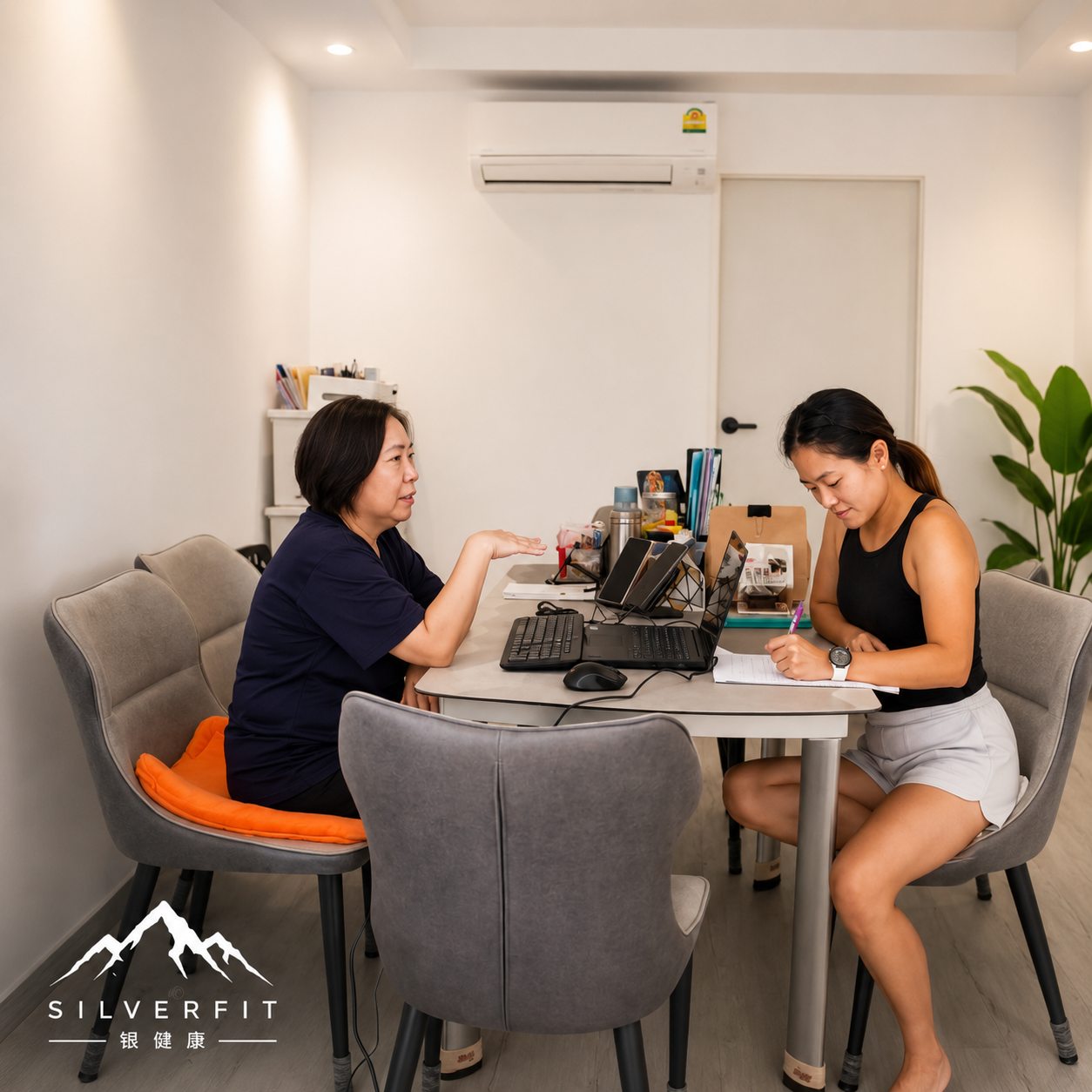 A SilverFit coach reviewing a personalised health and fitness assessment with a client